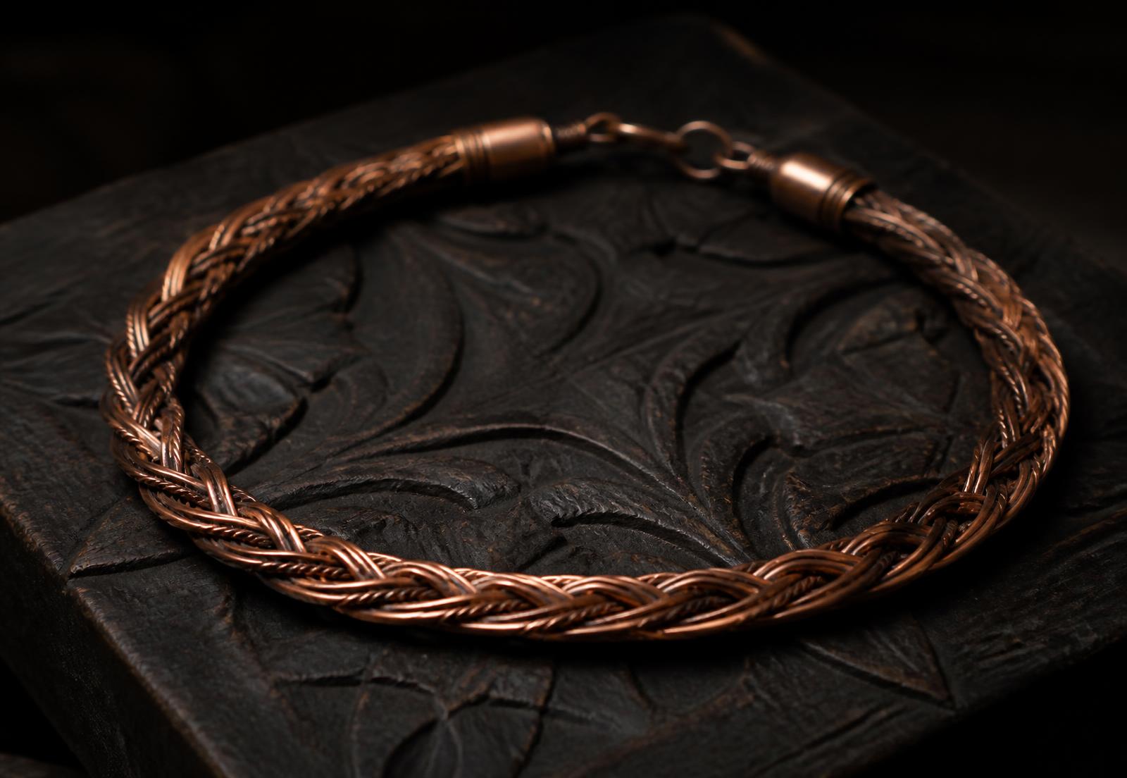Close detail of braided copper strands on a workbench